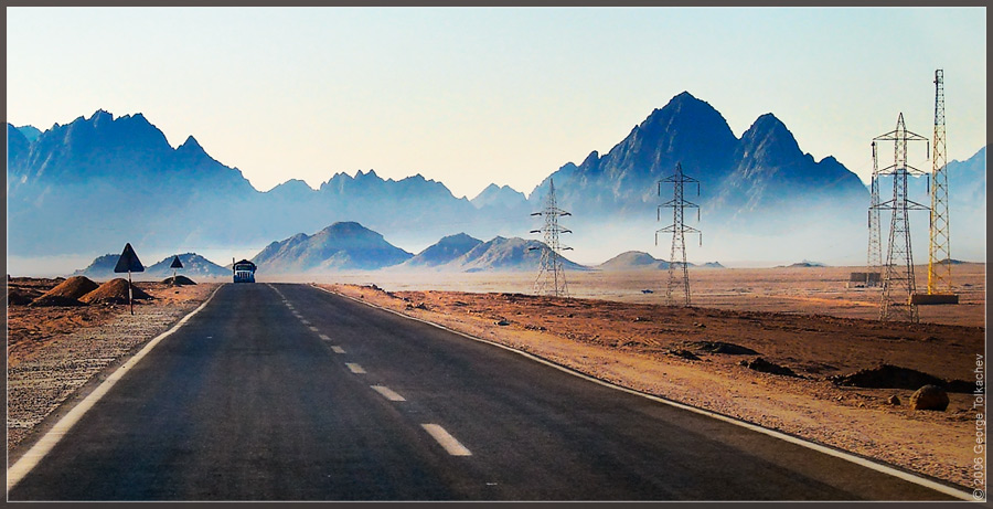 creeps out of fog... | desert, mountains, car, morning, road