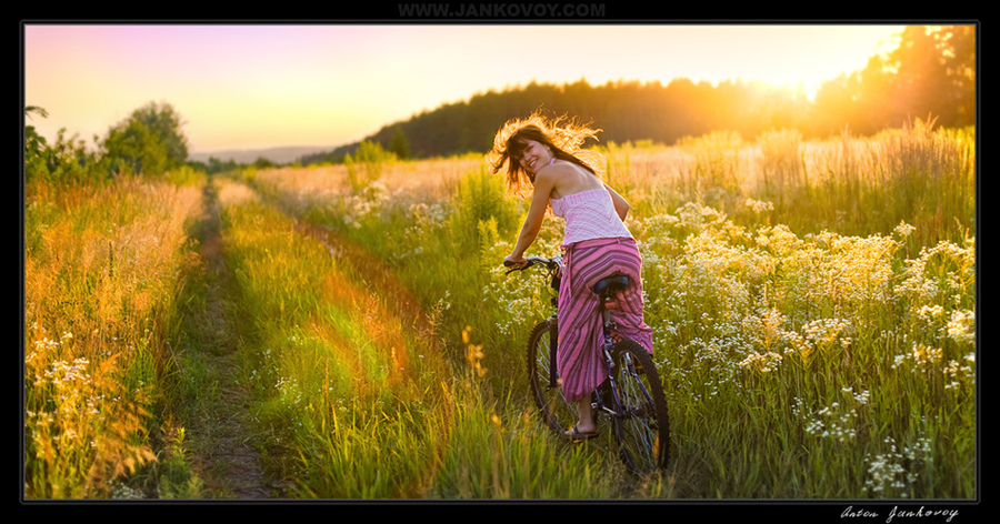 Catch up! | flowers, bicycle, girl, field, sun, light, people